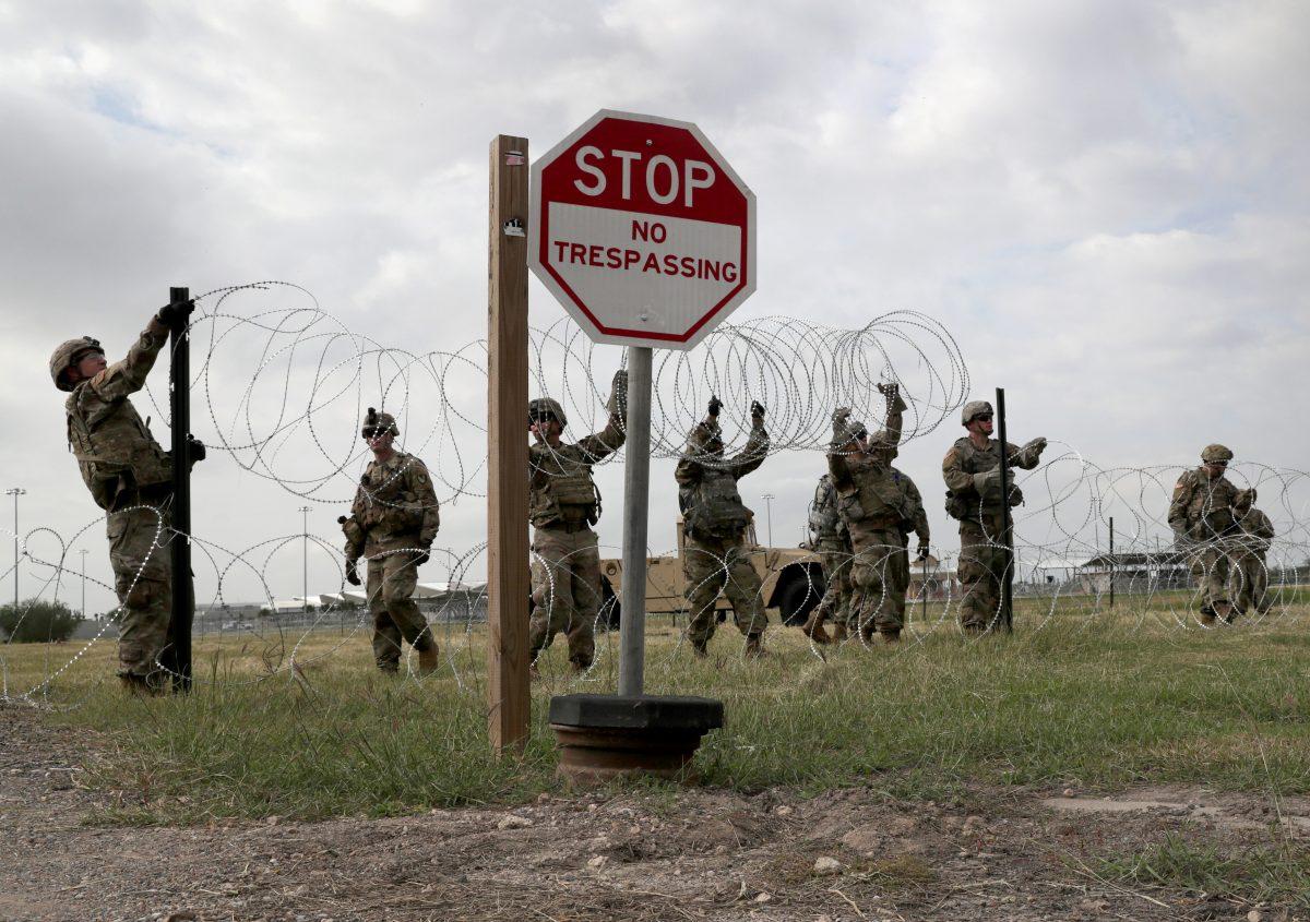 U.S. Army soldiers from Ft. Riley, Kansas, string razor wire near the port of entry at the U.S.-Mexico border in Donna, Texas, on Nov. 4, 2018. (John Moore/Getty Images)