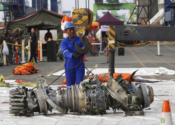 Officials move an engine recovered from the crashed Lion Air jet for further investigation in Jakarta, Indonesia, on Nov. 4, 2018. (Achmad Ibrahim/AP Photo)