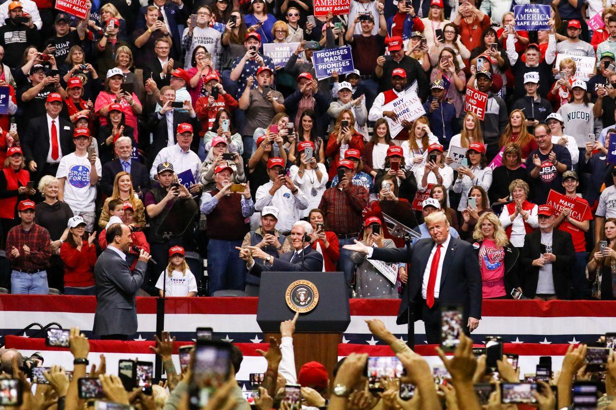 Singer Lee Greenwood, Vice President Mike Pence, and President Donald Trump at a Make America Great Again rally in Chattanooga, Tenn., on Nov. 4, 2018. (Charlotte Cuthbertson/The Epoch Times)