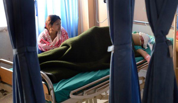 File photo of Sangita Magar resting on a hospital bed in Kathmandu, Nepal, on March 18, 2015, three weeks after surviving an acid attack. (Prakash Mathema/AFP/Getty Images)