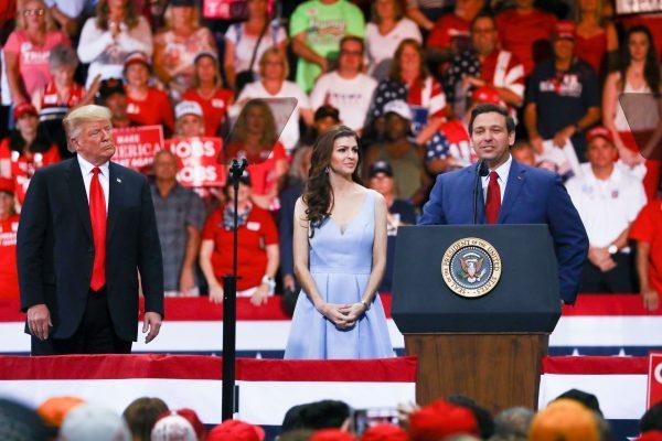 President Donald Trump, Florida GOP gubernatorial candidate Ron DeSantis (R), and his wife at a Make America Great Again rally in Fort Myers, Fla., on Oct. 31, 2018. (Charlotte Cuthbertson/The Epoch Times)