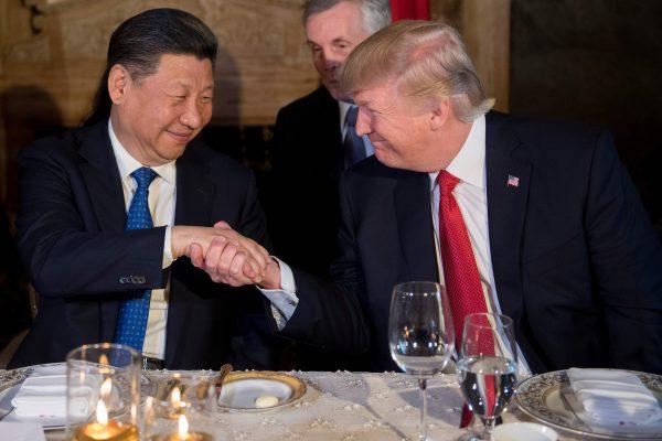 U.S. President Donald Trump (R) and Chinese leader Xi Jinping shake hands during dinner at the Mar-a-Lago estate in West Palm Beach, Florida, on April 6, 2017. (JIM WATSON/AFP/Getty Images)