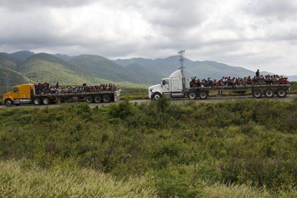 Migrants travel on trucks as the thousands-strong caravan of Central Americans migrants hoping to reach the southern United States border moved onward from Juchitan, Oaxaca state, Mexico, on Nov. 1, 2018. (AP Photo/Rodrigo Abd)