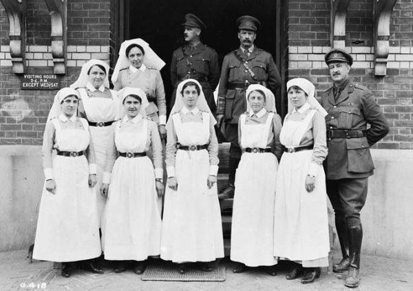Nursing sisters and officers outside No. 1 Casualty Clearing Station, France, July 1916. (Library and Archives Canada)