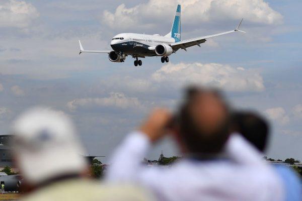 Visitors watch as a Boeing 737 Max lands after an air display during the Farnborough Airshow, southwest of London, on July 16, 2018. (Ben Stansall/AFP/Getty Images)