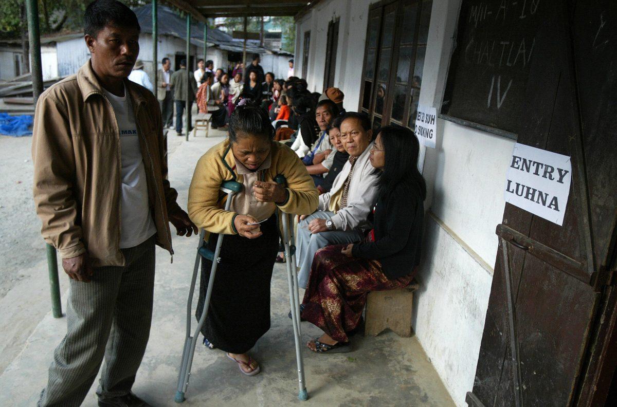 An Indian voter with disability is assisted at a polling station in Aizawl, capital of the north-eastern state of Mizoram on Dec. 2, 2008. India is working to draft a national policy on accessible elections ahead of the 2019 National elections. (Dipendu Dutta/AFP/Getty Images)