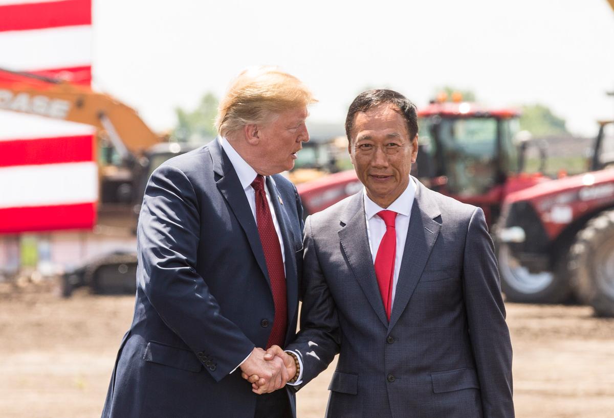President Donald Trump (L) shakes hands with Foxconn Chairman Terry Gou at the groundbreaking for the Foxconn Technology Group computer screen plant in Mt Pleasant, Wisconsin, on June 28, 2018. (Andy Manis/Getty Images)