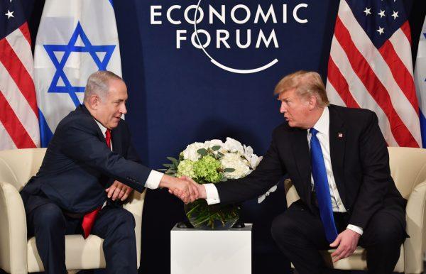 U.S. President Donald Trump (R) shakes hands with Israel's Prime Minister Benjamin Netanyahu during a bilateral meeting on the sidelines of the World Economic Forum (WEF) annual meeting in Davos, Switzerland, on Jan. 25, 2018. (Nicholas Kamm/AFP/Getty Images)