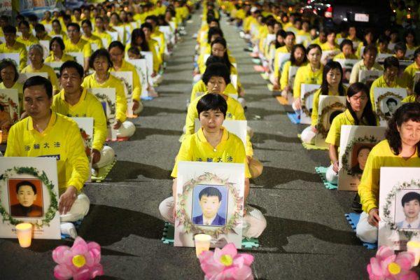 Falun Gong practitioners hold a candlelight vigil in front of the Chinese Consulate in Los Angeles for those who have died during the 16 year persecution in China, on Oct. 15, 2015. They demand that former Chinese regime leader Jiang Zemin, who ordered the persecution of Falun Gong in 1999, be brought to justice. (Benjamin Chasteen/The Epoch Times)