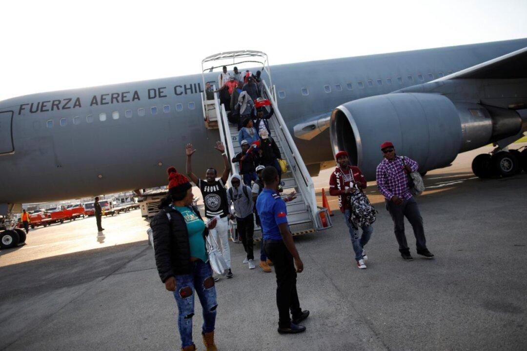 President of Chile Flies 176 Haitian Immigrants Home