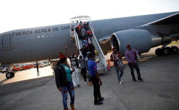 Haitians disembark from a Chilean Air Force plane as they return from Chile, upon their arrival to the International Airport of Port-au-Prince, Haiti, Nov. 7, 2018. (Reuters/Andres Martinez Casares)