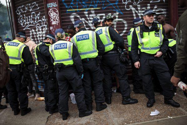 Police officers stop and search people on the final day of the Notting Hill Carnival in London on Aug. 27, 2018. (Jack Taylor/Getty Images)