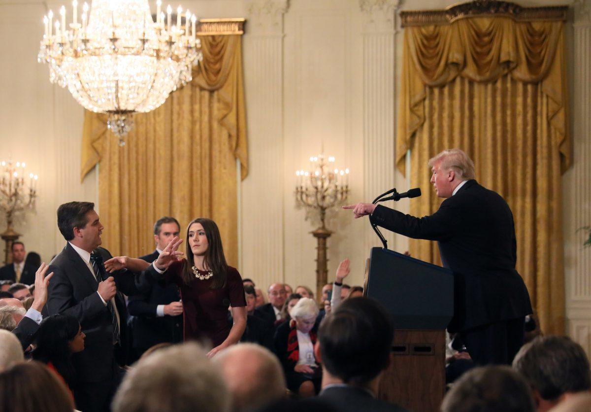 A White House staff member reaches for the microphone held by CNN's Jim Acosta at the White House in Washington on Nov. 7, 2018. (Jonathan Ernst/Reuters)