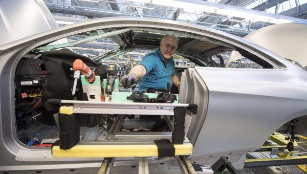 An employee works on a Mercedes-Benz S-Class Coupe on the assembly line at a Mercedes-Benz plant in Sindelfingen, Germany, on Jan. 24, 2018. (Thomas Kienzle/AFP/Getty Images)