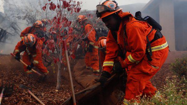 An inmate firefighter crew work to create a defensible space while battling the Camp Fire in Paradise, California, on Nov. 8, 2018. (Stephen Lam/Reuters)