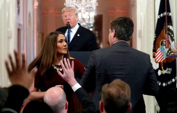 A White House staff member steps in to try to take the microphone away from CNN's Jim Acosta as he questions U.S. President Donald Trump during a news conference following Tuesday's midterm U.S. congressional elections at the White House in Washington, U.S., Nov. 7, 2018. (Kevin Lamarque/Reuters)