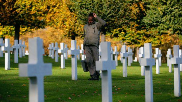 A cemetery employee walks between graves of American serviceman killed during WWI ahead of celebrations of the WWI centenary at the American Cemetery in Suresnes, on the outskirts of Paris, France, on Nov. 9, 2018. (Vadim Ghirda/AP)