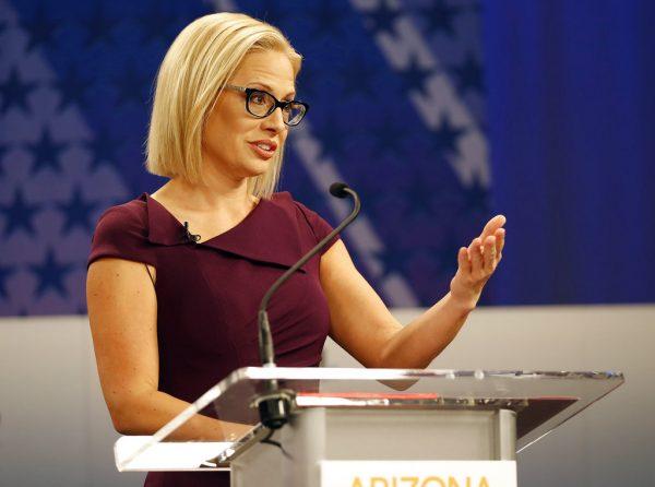 Rep. Kyrsten Sinema, (D-Ariz.), goes over the rules in a television studio prior to a televised debate with Rep. Martha McSally, (R-Ariz.), in Phoenix, Arizona, on Oct. 15, 2018. (AP Photo/Matt York)