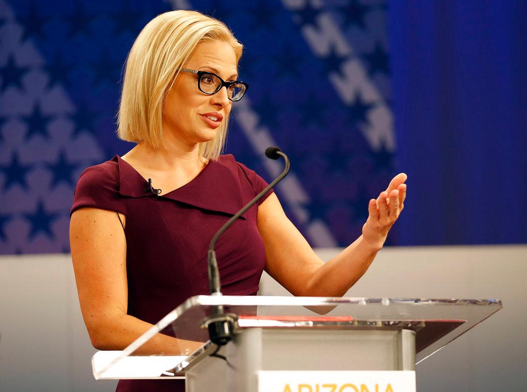 Rep. Kyrsten Sinema, (D-Ariz.), goes over the rules in a television studio prior to a televised debate with Rep. Martha McSally, (R-Ariz.), in Phoenix, Arizona, on Oct. 15, 2018. (AP Photo/Matt York)
