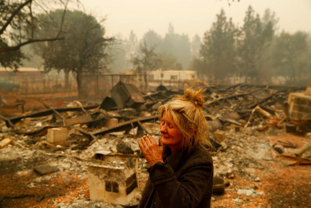 Cathy Fallon reacts as she stands near the charred remains of her home, Friday, Nov. 9, 2018, in Paradise, Calif. "I'll be darned if I'm going to let those horses burn in the fire," said Fallon, who stayed on her property to protect her 14 horses, all of which survived. (John Locher/AP Photo)