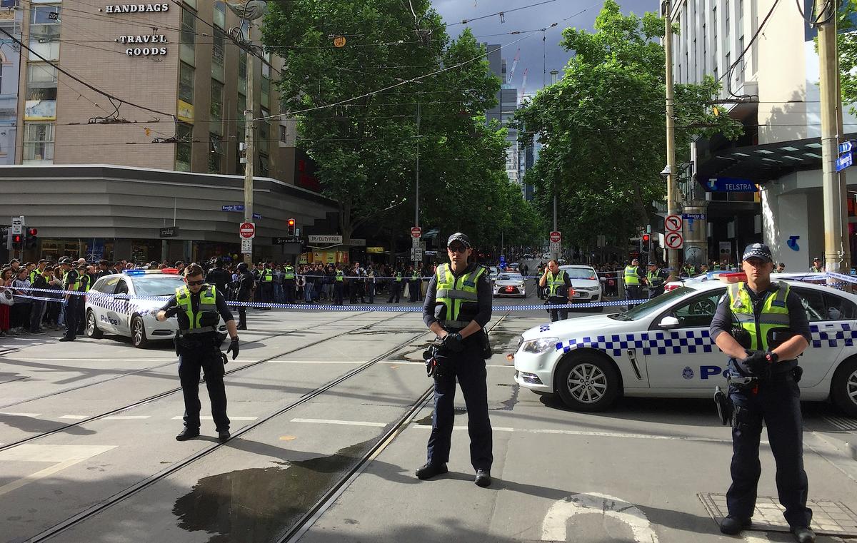 Policemen block members of the public from walking towards the Bourke Street mall in central Melbourne, Australia, on Nov. 9, 2018. (Reuters/Sonali Paul)