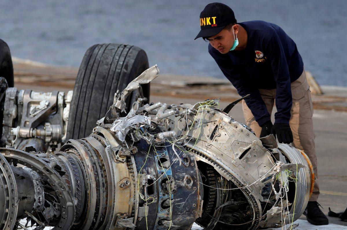An Indonesian National Transportation Safety Commission (KNKT) official examines a turbine engine from the Lion Air flight JT610 at Tanjung Priok port in Jakarta, Indonesia, on Nov. 4, 2018. (Beawiharta/Reuters)