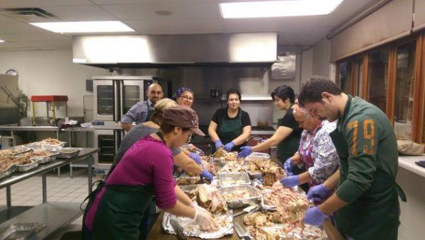 Volunteers inside St. Sarkis Armenian Orthodox Church of Carrollton, Texas, cut turkey to serve the homeless in 2015. (Courtesy of Operation Turkey)