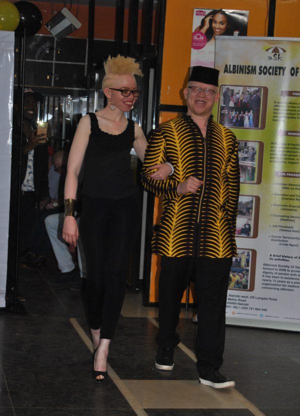Sen. Isaac Mwaura escorts a contestant for Mr. & Miss Albinism East Africa during auditions in Nairobi, Kenya, on Oct. 27, 2018. (Dominic Kirui/Special to The Epoch Times)