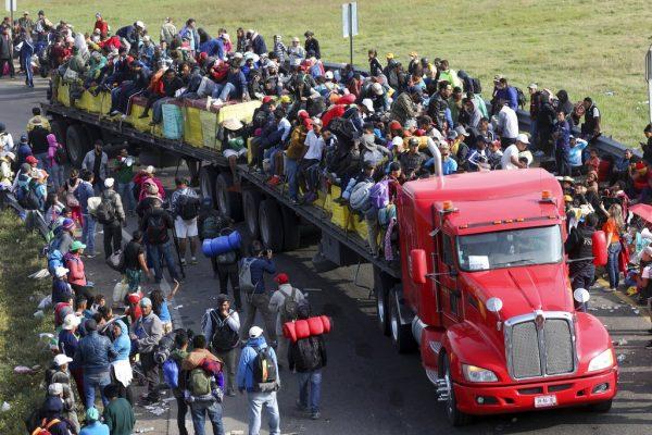 The main migrant caravan catches rides in Irapuato, Mexico, on Nov. 12, 2018. (AP Photo/Marco Ugarte)