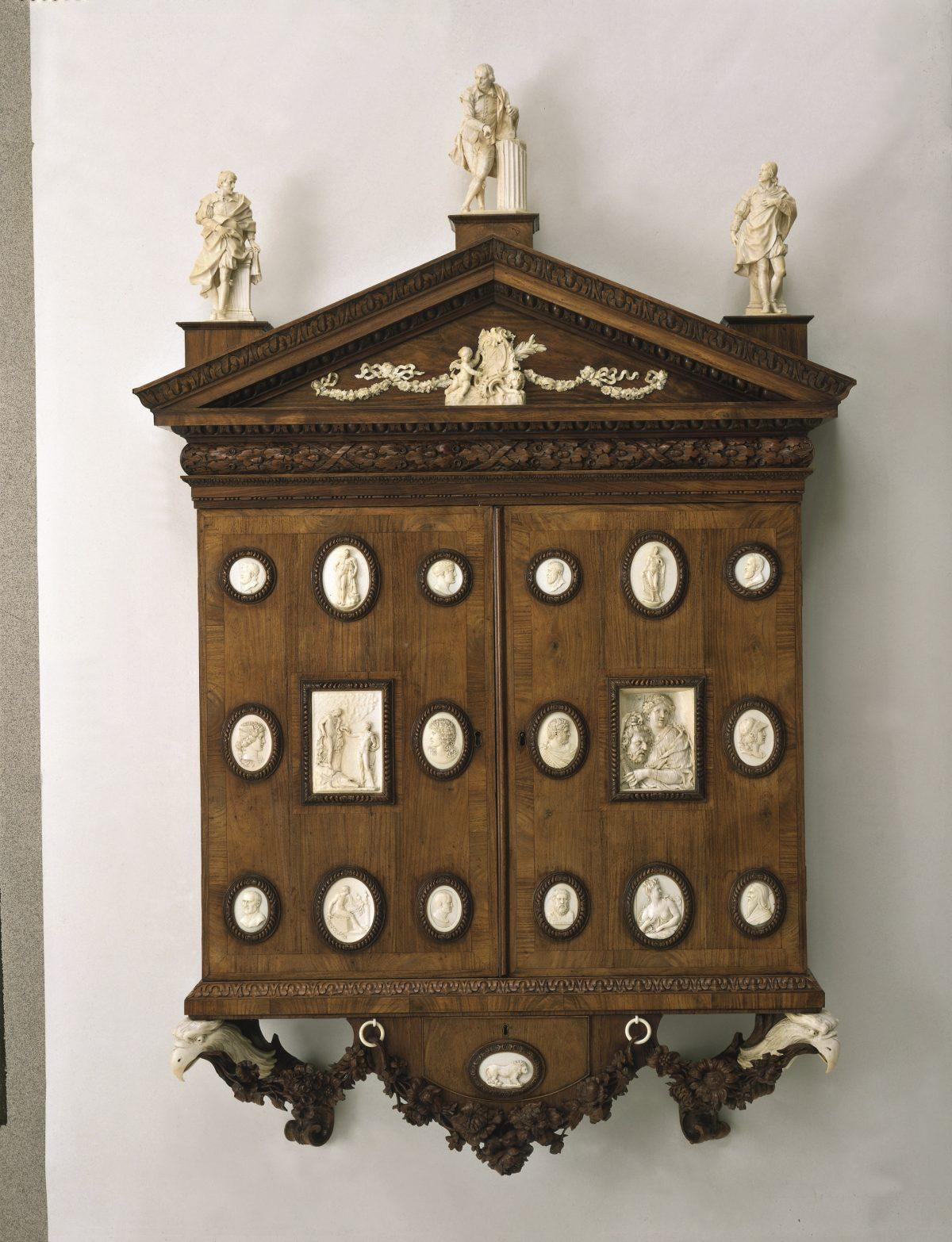 Cabinet of miniatures and enamels, designed by Horace Walpole, perhaps with William Kent. Perhaps made by William Hallett. Carving, 1743, by James Verskovis and Giovanni Battista Pozzo and anonymous hands. Padouk veneer, set with carved ivories, 60 inches high by 36 inches wide by 8 1/2 inches deep. (V&A images/Victoria and Albert Museum, London)