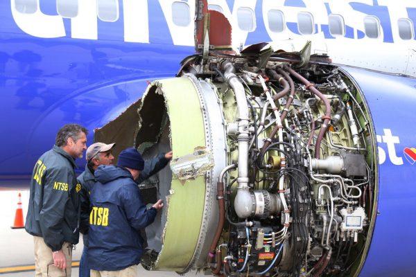 National Transportation Safety Board investigators examine damage to the engine of the Southwest Airlines plane that made an emergency landing at Philadelphia International Airport, Philadelphia, on April 17, 2018. (NTSB/AP)