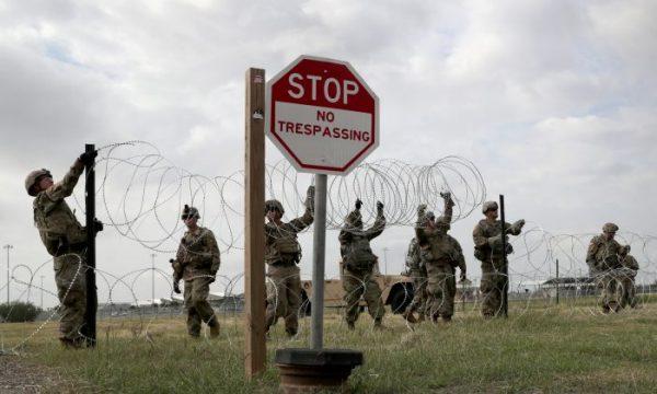 U.S. Army soldiers from Ft. Riley, Kansas, string razor wire near the port of entry at the U.S.-Mexico border in Donna, Texas on Nov. 4, 2018. (John Moore/Getty Images)