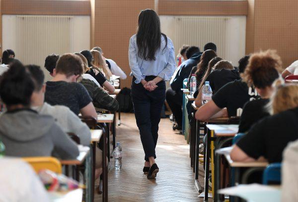 A teacher walks through a classroom during a high school exam in Strasbourg, France, on June 18, 2018. (Frederick Florin/AFP/Getty Images)