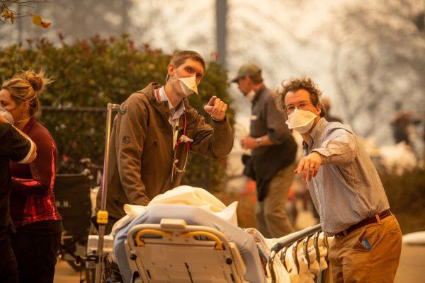 Patients are quickly evacuated from the Feather River Hospital as it burns down during the Camp Fire in Paradise, California, on Nov. 8, 2018. (Josh Edelson/AFP/Getty Images)
