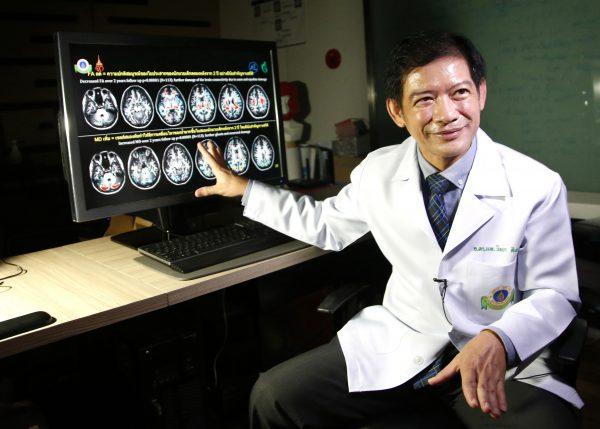 Dr. Witaya Sungkarat explains brain scans from young boxers at Ramathibodi Hospital, Thailand, on Nov. 14, 2018. (Sakchai Lalit/AP)