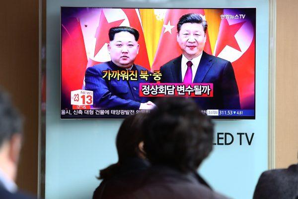 South Koreans watch a television broadcast reporting the North Korean leader Kim Jong-un met with Chinese leader Xi Jinping, airing at the Seoul Railway Station in Seoul, South Korea on March 28, 2018. (Chung Sung-Jun/Getty Images)