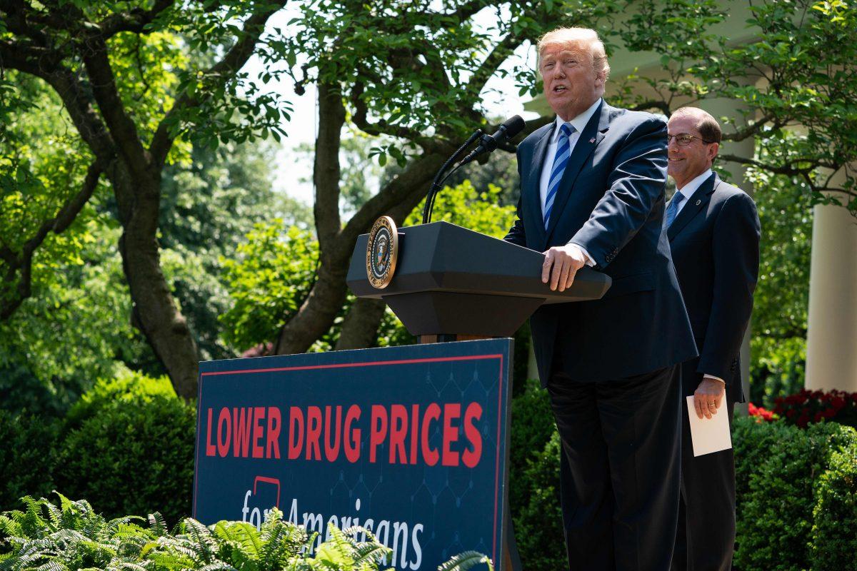 President Donald Trump delivers remarks with Health and Human Services Secretary Alex Azar (R) on reducing drug costs in the Rose Garden at the White House in Washington on May 11, 2018. (Nicholas Kamm/AFP/Getty Images)