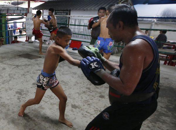 Thai kickboxer Chaichana Saengngern, 10, spars at a training camp in Bangkok, Thailand, on Nov. 14, 2018. (Sakchai Lalit/AP)