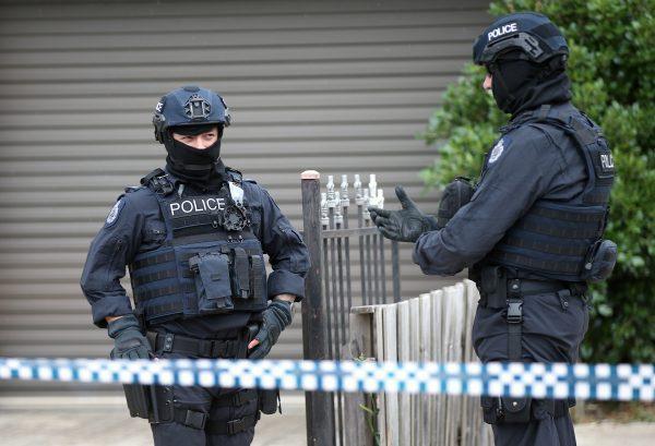 Police officers that form part of the Australian Joint Counter Terrorism Team stand outside a home they raided as part of an operation in which they arrested three men who were allegedly preparing to attack the public in Melbourne, Australia, on Nov. 20, 2018. (AAP/David Crosling/via Reuters)