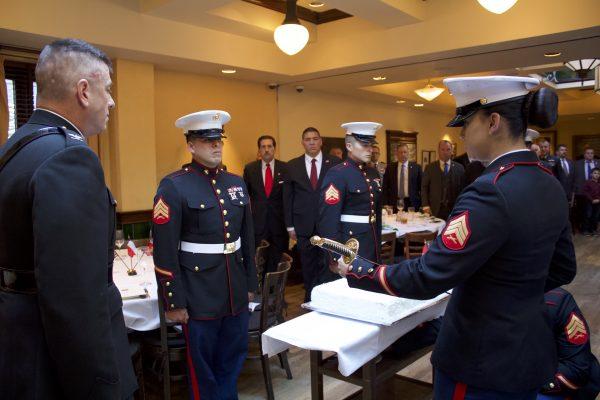 Marines stand at attention as Sgt. Elizabeth Rodriguez hands a USMC NCO sword to Col. Ivan I. Monclova, so he can cut the cake at the 243rd Marine Corps birthday celebrations in New York City on Nov. 8, 2018. (Margaret Wollensak/The Epoch Times)
