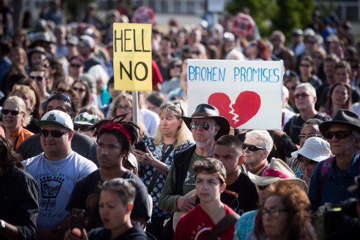 People listen during a protest against the Kinder Morgan Trans Mountain Pipeline expansion in Vancouver on May 29, 2018. (The Canadian Press/Darryl Dyck)