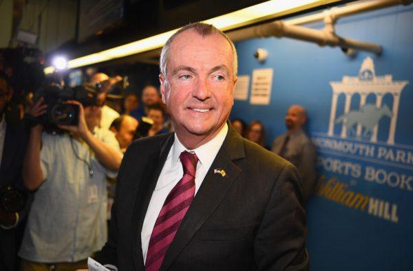 The governor of New Jersey, Phil Murphy, places the first bet at the William Hill Sports Book at Monmouth Park in Oceanport, N.J., on June 14, 2018. (Kotinsky/Getty Images for William Hill Race & Sports Bar )