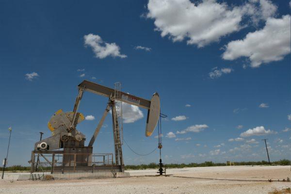 A pump jack operates in the Permian Basin oil production area near Wink, Texas, on Aug. 22, 2018. (Nick Oxford/Reuters)
