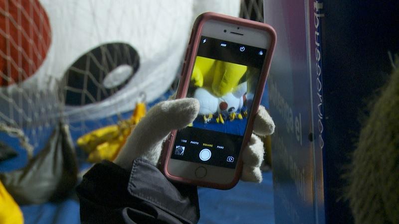 Woman takes picture of Pikachu in during the Macy's Thanksgiving Eve Blow-up in New York City, NY on Nov. 21 (Oliver Trey/NTD News)