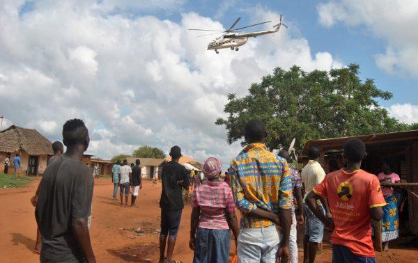 Residents look at a police helicopter patrolling near the location where Italian charity worker Silvia Romano was kidnapped in Kilifi county, Kenya, on Nov. 21, 2018. (Reuters/Stringer)