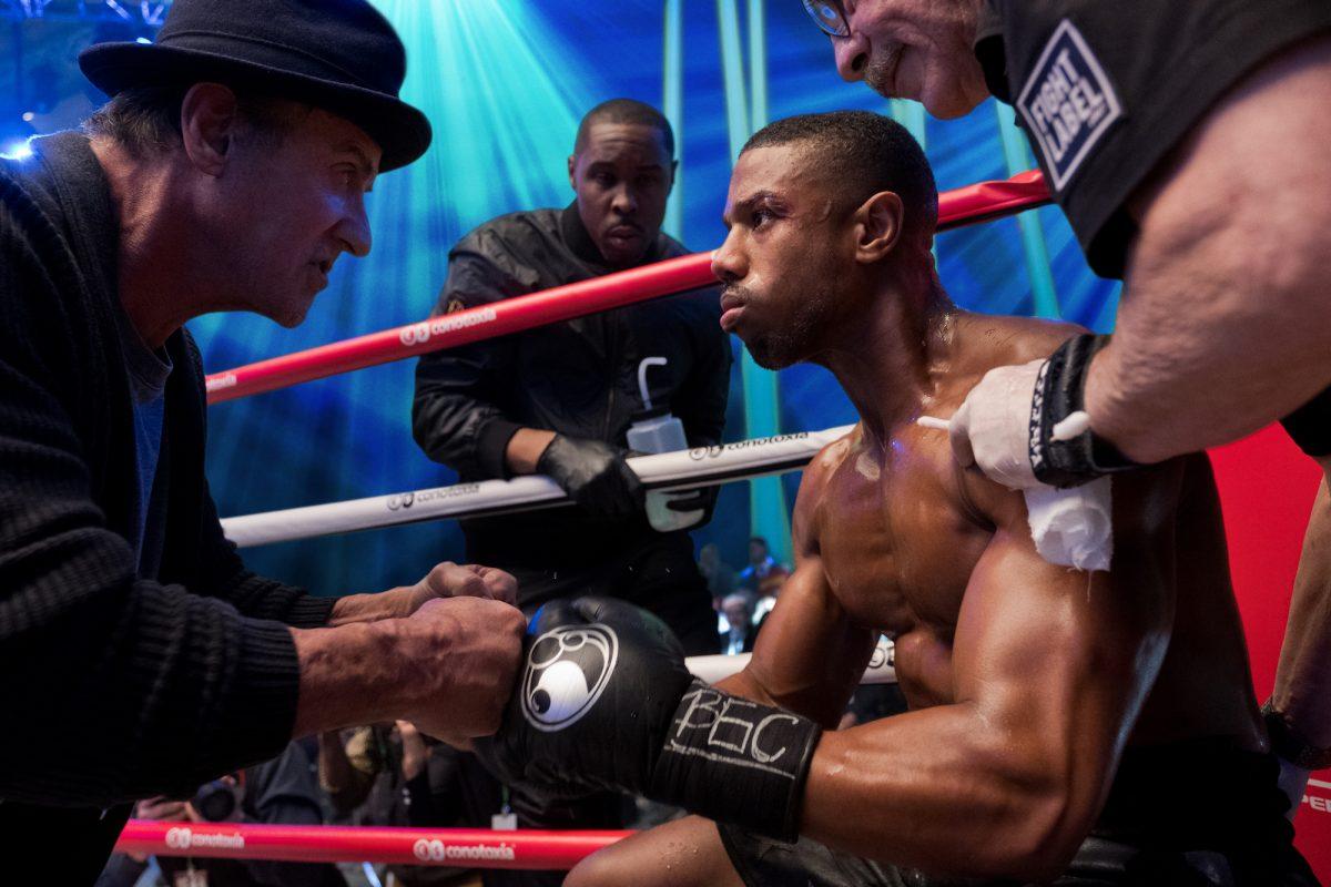 (L–R) Rocky Balboa (Sylvester Stallone), Tony "Little Duke" Burton (Wood Harris), Adonis Creed (Michael B. Jordan), and Stitch-Cutman (Jacob "Stitch" Duran) in “Creed II,” a Metro Goldwyn Mayer Pictures and Warner Bros. Pictures film. (Barry Wetcher/Metro Goldwyn Mayer Pictures/Warner Bros. Pictures)