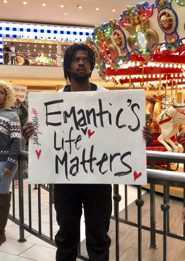 Elijah King holds a sign during a protest at the Riverchase Galleria mall in Hoover, Ala., on Nov. 24, 2018. (Kim Chandler/AP)