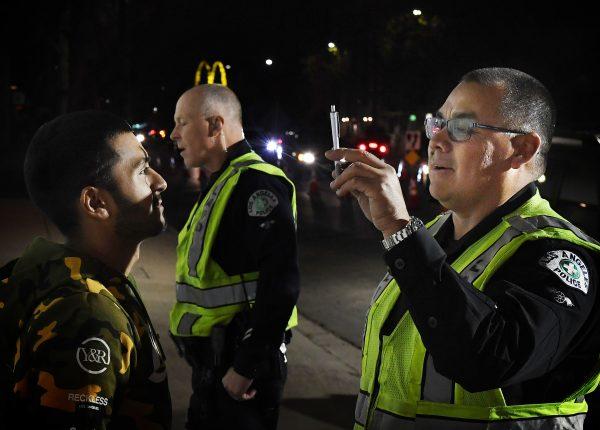 A man undergoes a sobriety test before being detained at a LAPD police DUI checkpoint in Reseda, Los Angeles, California on April 13, 2018. (Mark Ralston/AFP/Getty Images)