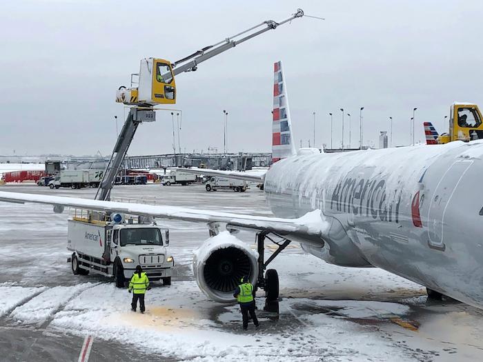 Crews de-ice an American Airlines plane at O'Hare International Airport Monday, Nov. 26, 2018, in Chicago. (Noreen Nasir/AP Photo)