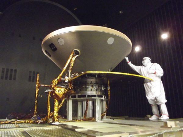 In this 2015 photo made available by NASA, a technician prepares the InSight spacecraft for thermal vacuum testing in its "cruise" configuration for its flight to Mars, simulating the conditions of outer space at Lockheed Martin Space Systems in Denver. NASA’s three-legged, one-armed geologist known as InSight makes its grand entrance through the rose-tinted Martian skies on Nov. 26, 2018. (NASA/JPL-Caltech/Lockheed Martin via AP)